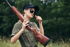 Woman green sunglasses weapon hunting lifestyle overalls photo