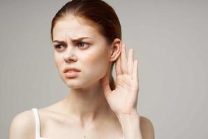 sick woman ear pain otitis media health problems infection light background photo