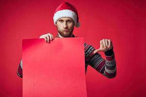 Cheerful man in New Year's clothes advertising copy space studio posing photo