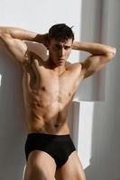 man with muscular body in black panties posing photo