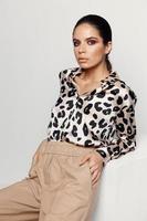 attractive woman in leopard shirt fashion style studio photo