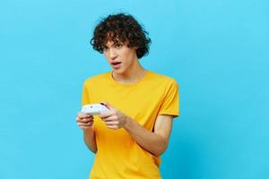 gamer plays with joystick in yellow t-shirts Lifestyle entertainment photo