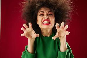 Pretty young female grimace afro hairstyle red lips fashion color background unaltered photo
