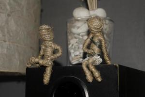 voodoo couple dolls sitting on sound system box. romantic scene photography concept photo