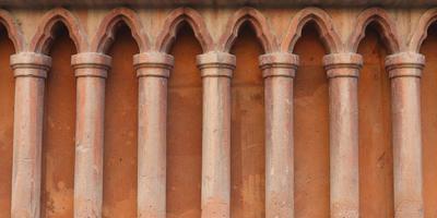 Classical pillars detail on the facade of a building concept photo. Classical pillars in a row. Urban architectural photography. photo