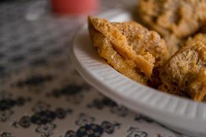 Close up photo of Tahu Walik Javanese traditional food with golden color. The photo is suitable to use for traditional food background, poster and food content media.