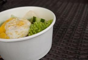 Close up photo fried rice with eggs and lettuce. The photo is suitable to use for traditional food background, poster and food content media.