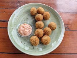 Chicken Ball on the green plate with mayonnaise sauce, snack menu on coffee shop. The photo is suitable to use for traditional food background, poster and food content media.