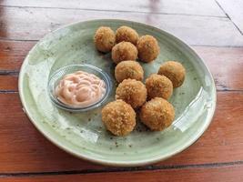 Chicken Ball on the green plate with mayonnaise sauce, snack menu on coffee shop. The photo is suitable to use for traditional food background, poster and food content media.