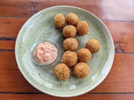 Chicken Ball on the green plate with mayonnaise sauce, snack menu on coffee shop. The photo is suitable to use for traditional food background, poster and food content media.