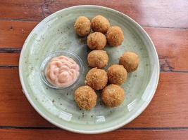 Chicken Ball on the green plate with mayonnaise sauce, snack menu on coffee shop. The photo is suitable to use for traditional food background, poster and food content media.