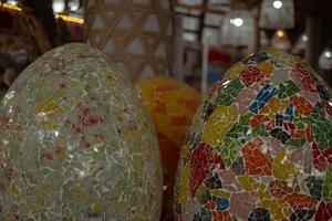 Decorative interior on the gallery shop, with many things, eggs glass, wall painting and the bucket gift. The photo is suitable to use for traditional food background, poster and food content media.