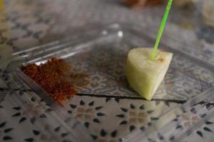 Traditional fruit salad with chili powder on the cafe shop. The photo is suitable to use for traditional food background, poster and food content media.