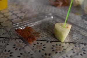 Traditional fruit salad with chili powder on the cafe shop. The photo is suitable to use for traditional food background, poster and food content media.