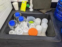 Lot of bottle sample on the sink laboratory, after chemical cleaning. photo