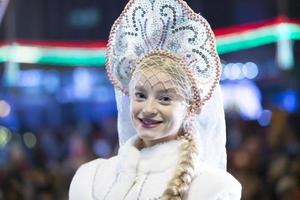 Belarus, the city of Gomil, December 10, 2019. The holiday of lighting the Christmas tree. Beautiful Russian snow maiden at the Christmas holiday. photo