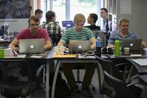 Belarus, the city of Minsk. Programmers Office. Programmers at work. IT specialists at the desktops. photo