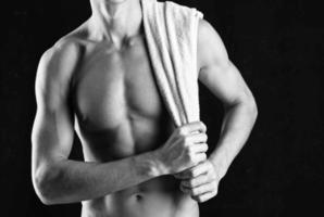man in white panties such black body fitness posing dark background photo