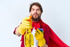 Man with detergent cleaning professional red raincoat cropped view of housework photo