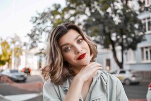 cheerful pretty woman close-up on the street in summer photo