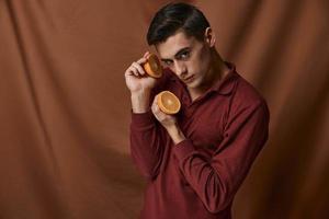 Handsome man red shirt oranges attractive look Model Studio photo