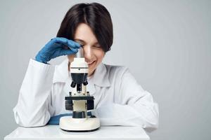 woman scientist laboratory science research microscope photo