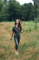 Woman in the forest walking through the field outdoor activities photo