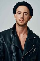 handsome man in leather jacket hat posing studio fashion photo