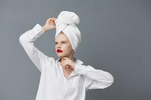 glamorous woman with a towel on his head in a white shirt studio model unaltered photo