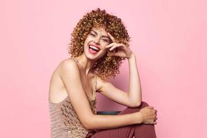 Charming model woman in pants and a T-shirt curly hair bright makeup photo