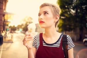 short haired woman outdoors eating ice cream walk lifestyle photo