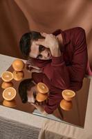 A handsome man oranges attractive look sits at the table photo