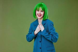 Pretty young female Glamor green wig red lips blue jacket color background unaltered photo