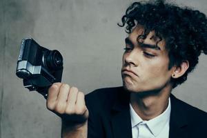 stylish man with camera in hand photography studio curls model portrait photo