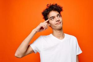 Cheerful guy in white t-shirt hand gesture emotions Studio photo