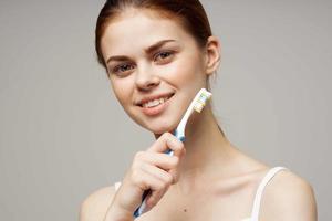 woman toothpaste brushing teeth dental health isolated background photo
