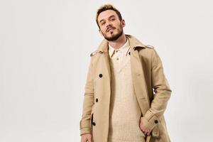 man in beige coat fashionable hairstyle attractive look Studio photo