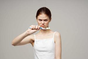 woman toothpaste brushing teeth dental health isolated background photo