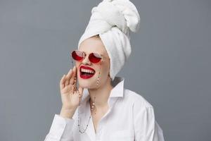 portrait of a woman with a towel on his head in a white shirt isolated background photo