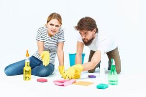 Young couple wash floors at home interior light background lifestyle photo