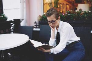 short haired woman with a book in his hands reading education photo