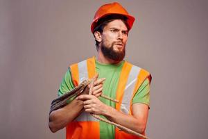 Male builder orange hard hat work Professional gray background photo