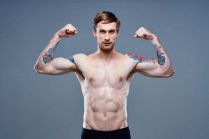 tattooed man naked torso bodybuilder Fitness portrait close-up photo