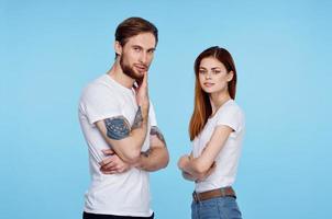 young couple in white t-shirts images of communication with him studio photo