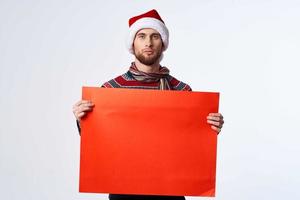 Cheerful man in New Year's clothes holding a banner holiday isolated background photo