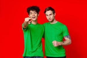 Two cheerful friends hug green t-shirts emotions photo