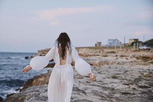 woman with wet hair in white dress stony coast photo