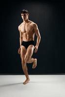 handsome athletic man in dark shorts posing bodybuilder photo