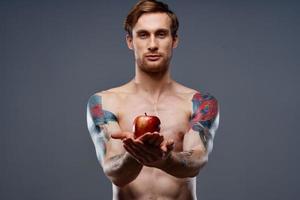 athletic men bodybuilding fitness press pumped up arm muscles tattoo red apple photo