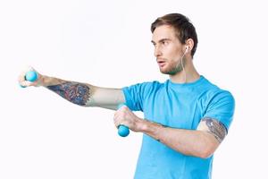 man with dumbbells in hands workout exercise fitness blue background photo